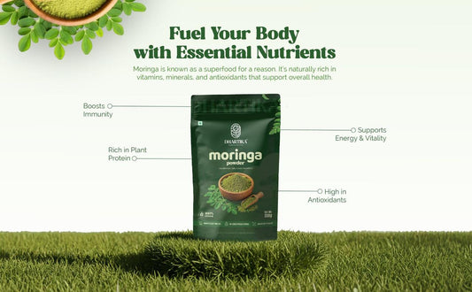 Dhartika Moringa powder surrounded by fresh moringa leaves